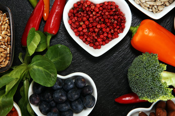 Healthy food clean eating selection. fruit, vegetable, seeds, superfood, cereals, leaf vegetable on rustic background