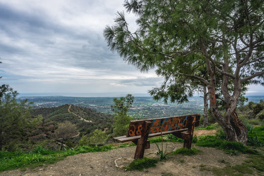Near Pyrga, Larnaca District/Cyprus - February 2019: Wooden bench in the mountain near the Stavrovouni Monastery in Cyprus. Beautiful landscape view. 