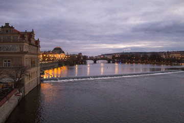 Fototapeta premium Bright lights of evening Prague, cityscape of Prague bridges, view of Charles Bridge