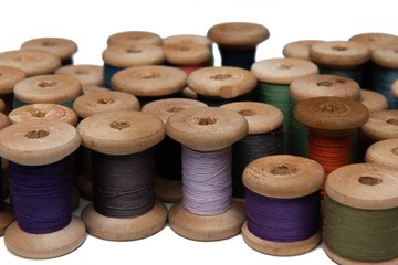 Fototapeta na wymiar wooden coils with colorful threads of pastel colors