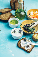 Cream Cheese on a slice of bread topped and dried olives