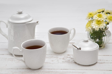 Fototapeta na wymiar teatime cups of tea on wooden white table