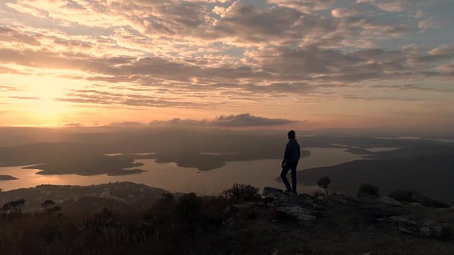 man and walking at sunset and looking at sunrise