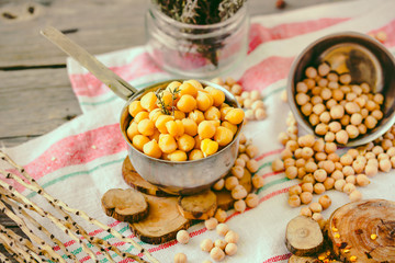 Dried and boiled chickpeas. Vegetarian protein. Dry thyme sprigs in a jar. Healthy lifestyle and balanced food concept. Selective focus.