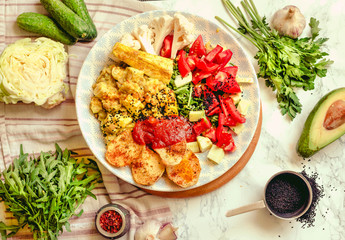 Green fresh salad with tomatoes, pink lentil mashed potatoes, baked potato slices with homemade ketchup.Vegetarian spring lunch bowl.. Top view.