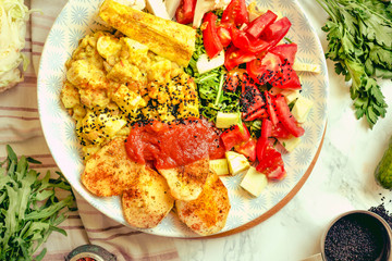 Green fresh salad with tomatoes, pink lentil mashed potatoes, baked potato slices with homemade ketchup.A large plate of healthy food for dinner.Top view.Close-up.