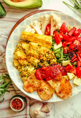 Green fresh salad with tomatoes, pink lentil mashed potatoes, baked potato slices with homemade ketchup.Full meal and Healthy vegan lunch dish concept.Top view.