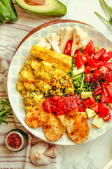 Green fresh salad with tomatoes, pink lentil mashed potatoes, baked potato slices with homemade ketchup.Full meal and Healthy vegan lunch dish concept.Top view.