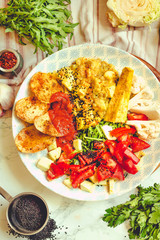 Green fresh salad with tomatoes, pink lentil mashed potatoes, baked potato slices with homemade ketchup.Comfort food concept. Top view.Toning.