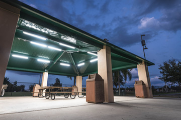 Well Lit Covered Park Area With Table At Dark 
