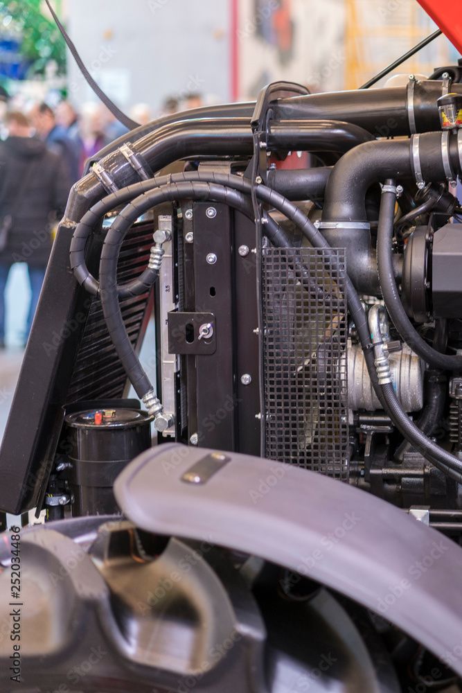 Poster Modern new agricultural diesel tractor engine. Modern new hi-tech engine of loader or small tractor. Top view. The big new engine on a show window. vertical photo