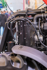 Fototapeta premium Modern new agricultural diesel tractor engine. Modern new hi-tech engine of loader or small tractor. Top view. The big new engine on a show window. vertical photo
