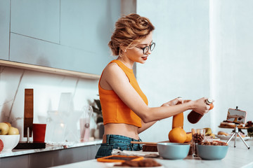 Positive nice woman cooking a healthy breakfast