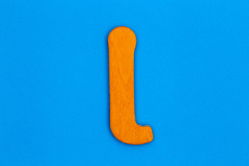 Wooden letter i painted orange on a blue background
