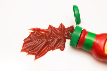 Ketchup tomato pasta pouring from bottle on white background