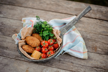 View from above on the georgian Mchadi in the pot on a light striped tablecloth