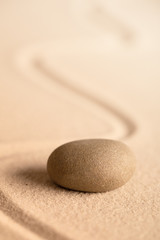 Fototapeta na wymiar spa wellness relaxation stone. Concept for harmony spirituality and mental health. Japanese zen meditation garden with rock in raked sand.