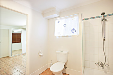 Fototapeta na wymiar Small bathroom with toilet and glass shower