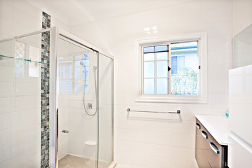 Modern white bathroom interior with glass shower