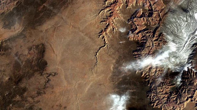 Aerial satellite view of moving clouds on grand canyon animation. Contains public domain image by Nasa