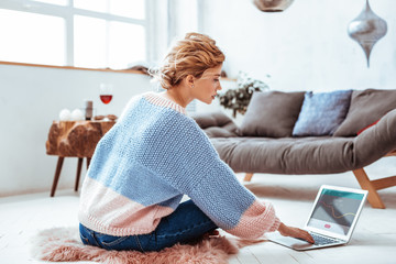 Pleasant good looking woman working remotely on the internet