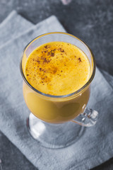 Yogurt with turmeric on gray background, above