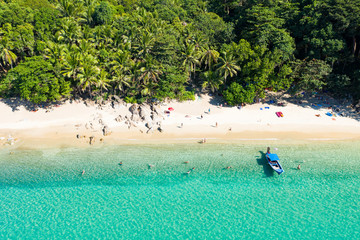 View from above, aerial view of a beautiful tropical beach with white sand, turquoise clear water, long-tail boat and people sunbathing, Banana beach, Phuket, Thailand. - obrazy, fototapety, plakaty