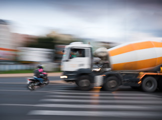 Dangerous city traffic situation with a motorcyclist and a truck