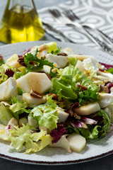 Mix of salad with walnut, pear and goat cheese.