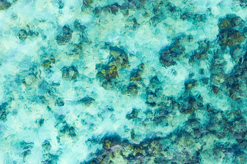 View from above, stunning aerial view of a beautiful transparent and turquoise sea that creates a natural pattern, Phi Phi Island, Thailand.