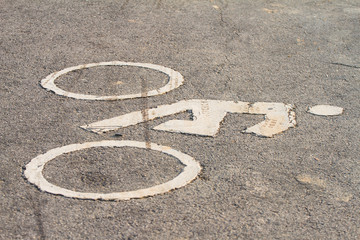 Fototapeta premium Symbols of bicycle on the street suggests that a bike lane.
