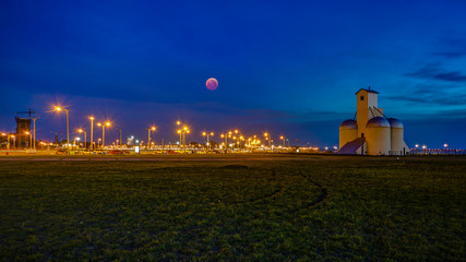 Dusk / blue hour with blood moon at Playa San Jose of Encarnacion in Paraguay..