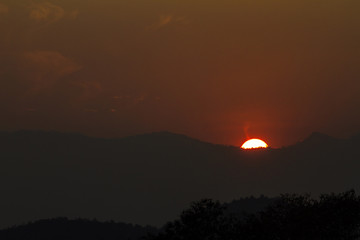 View of the sunset behind the mountains.