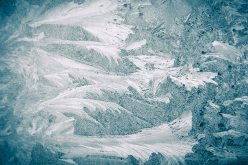 Frosty patterns on the window, close-up. Beautiful frosty background, from patterns on the window. Frozen windows.
