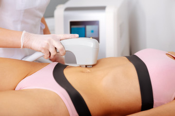 Depilatory master making laser hair removal near navel