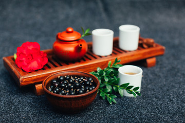 Traditional Chinese tea ceremony with black currant, fruit tea and healthy food.