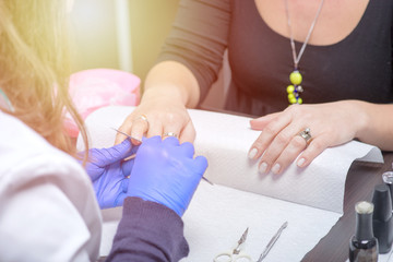 Nail care in salon. Selective focus on costumer's nails.