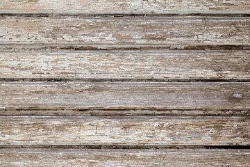 Wooden stockade background. Close-up of gray wooden planks of the old wall. Wood texture with peeling paint