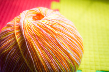 Knitting skein on a multicolored background.