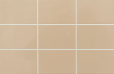 Beige ceramic tile on the wall in the bathroom. Background from beige tiles.