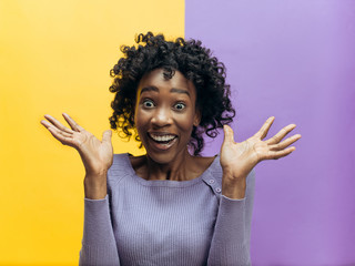 I won. Winning success happy woman celebrating being a winner. Dynamic image of african female model on studio background. Victory, delight concept. Human facial emotions concept. Trendy colors