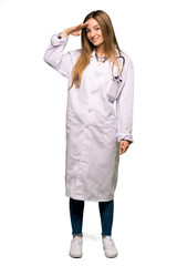 Full body Young doctor woman saluting with hand on isolated background