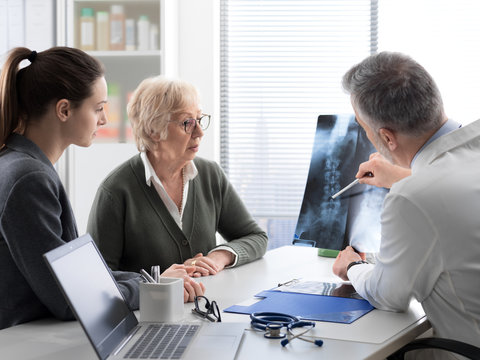 Doctor checking a senior patient's x-ray image