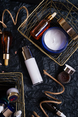 set of nature precious oils and  care cosmetics on black background .