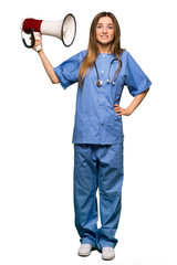 Full body Young nurse taking a megaphone that makes a lot of noise on isolated background