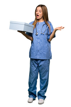 Full Body Young Nurse Holding Gift Box In Hands On Isolated Background