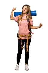 Full body Young backpacker woman enjoy dancing while listening to music at a party on isolated background