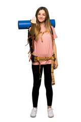 Full body Young backpacker woman inviting to come with hand. Happy that you came on isolated background