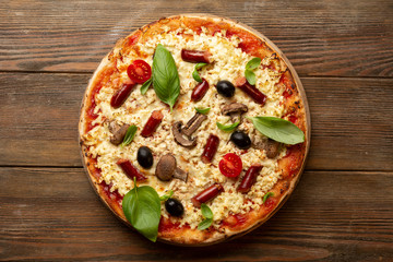 Fresh pizza on wood above