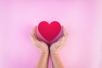 Obraz premium womans hands around heart on isolated background